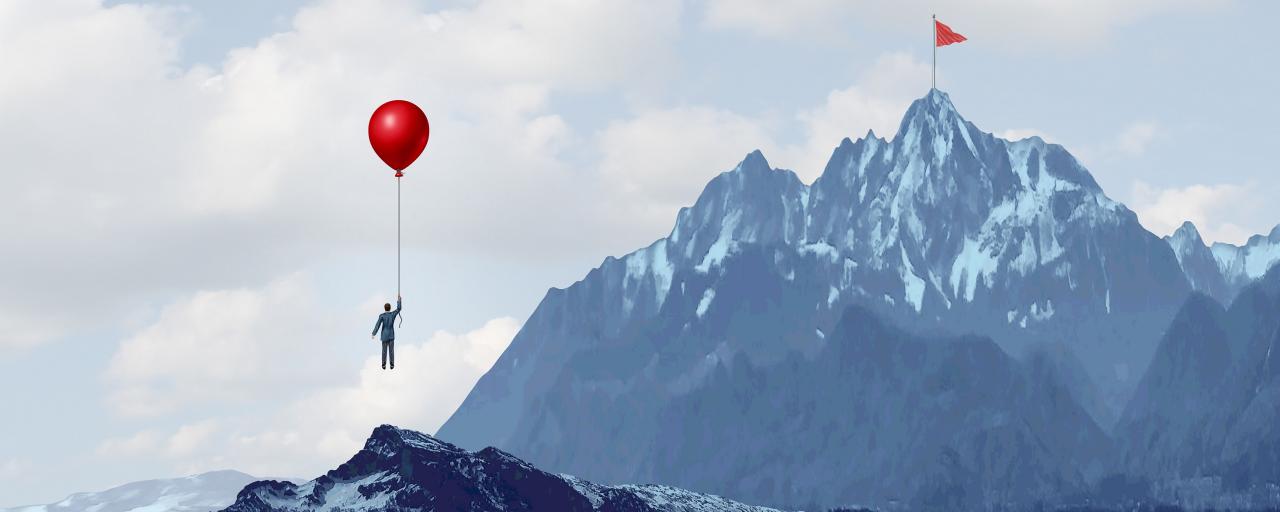 Unconventional thinking: man with balloon rises to reach target