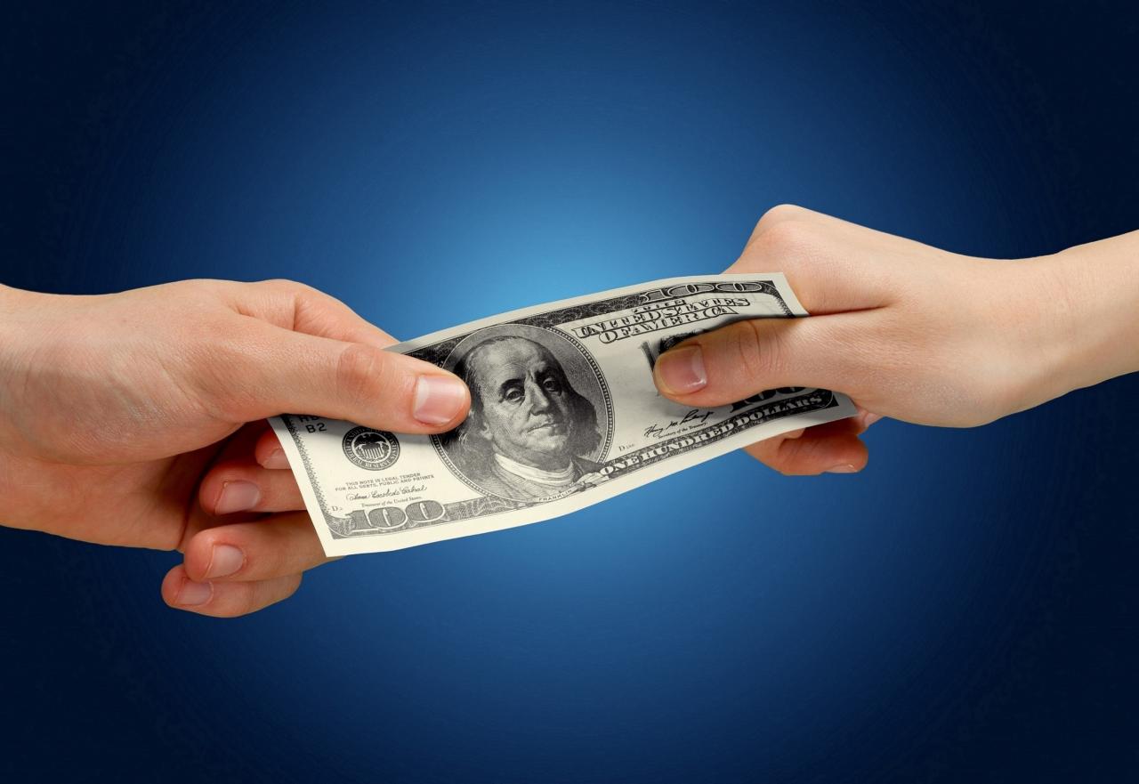 two hands fighting over money