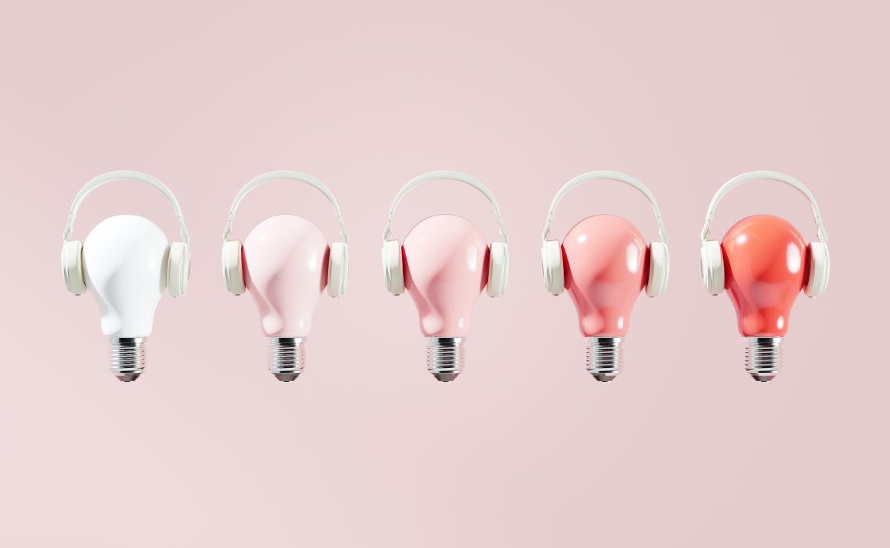 a row of lightbulbs with headphones on