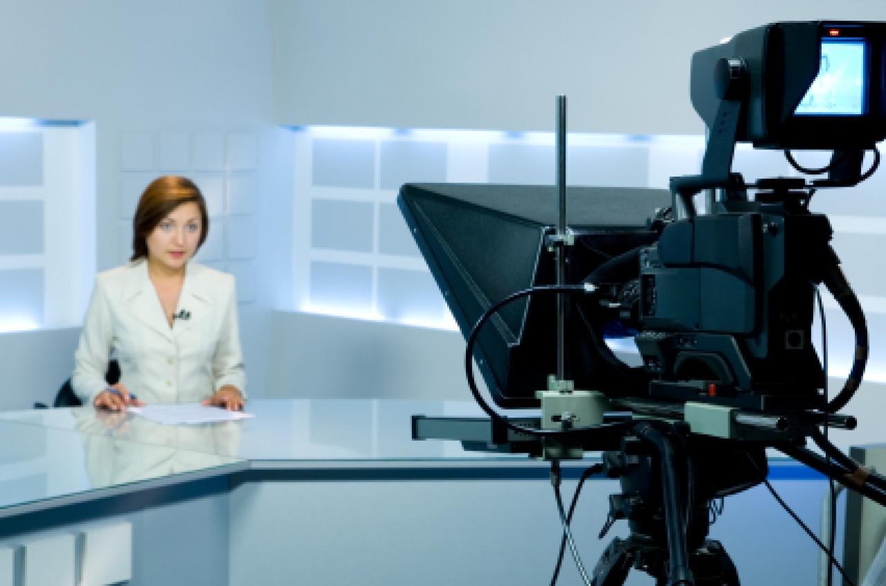 Female news presenter in studio Female news presenter in studio